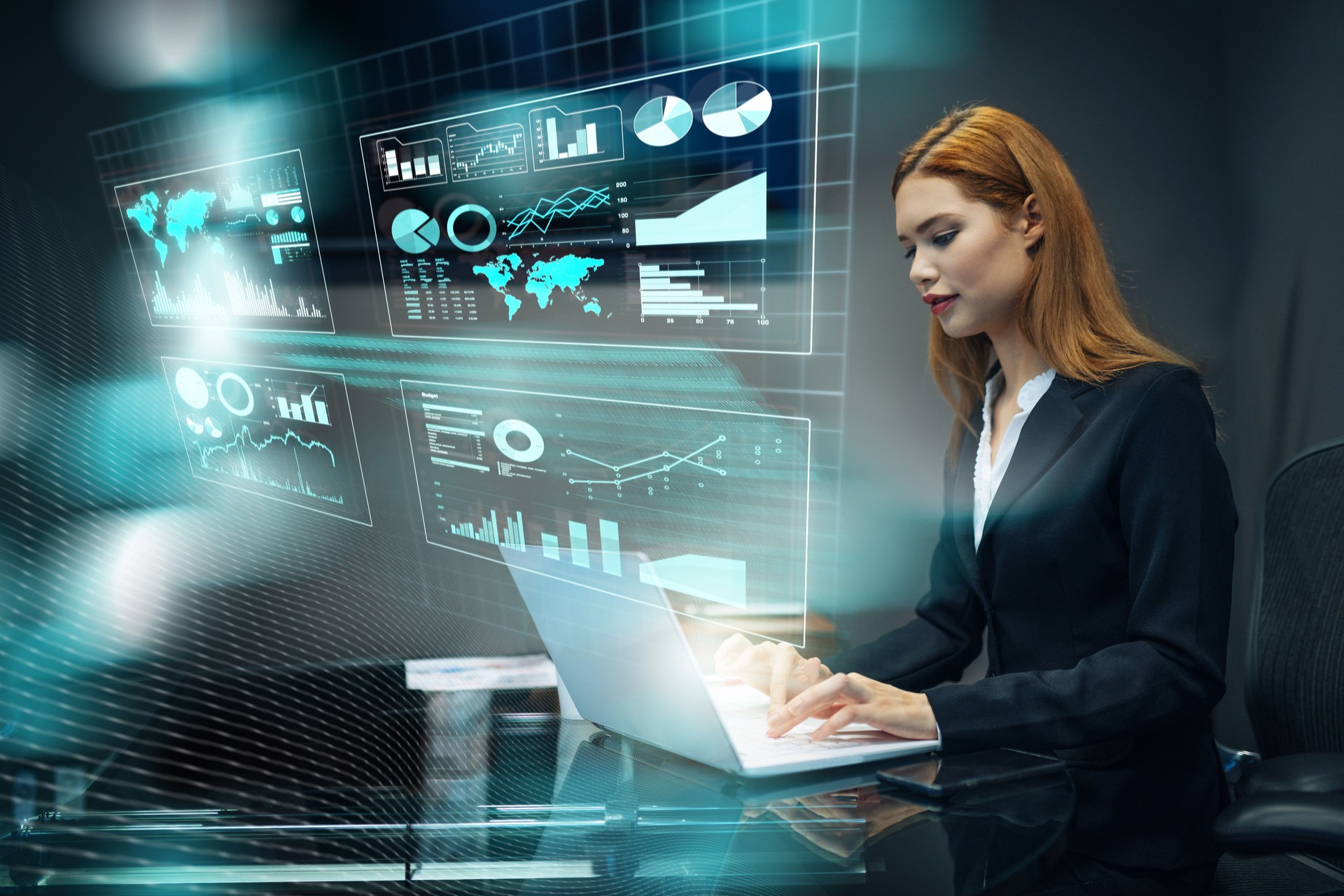 Businesswoman working on a laptop surrounded by digital graphics and financial data in a modern office setting, presenting artificial intelligence in business and finance